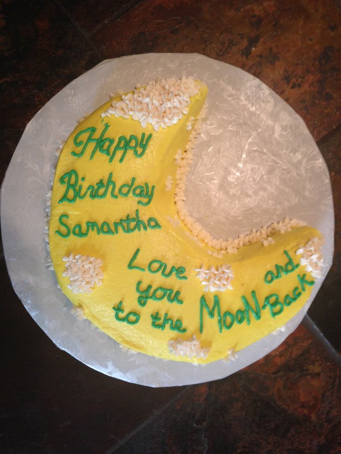 Yellow crescent moon birthday cake that says Love you to the moon and back